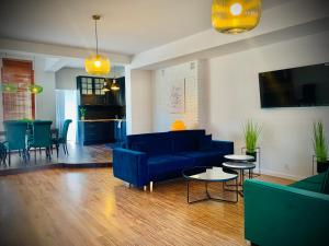 a living room with a blue couch and a table at Apartamenty Krasicki in Lidzbark Warmiński