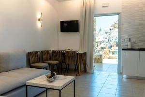 a living room with a couch and a table at K suites ios in Ios Chora