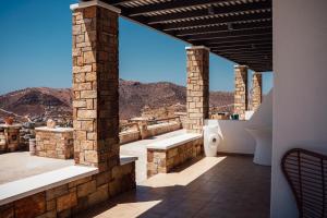 a balcony with a view of the mountains at K suites ios in Ios Chora