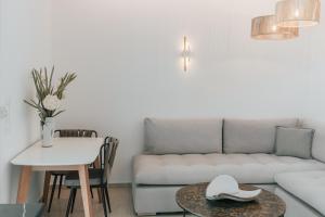 a living room with a couch and a table at K suites ios in Ios Chora