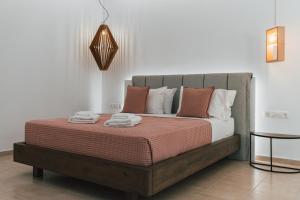 a bedroom with a bed with towels on it at K suites ios in Ios Chora
