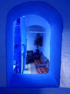 a tv screen showing a living room with a plant at Riad Mauritania in Chefchaouen