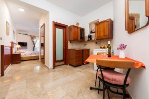 a kitchen with a table and a dining room at Nonna Marija 1 in Rovinj