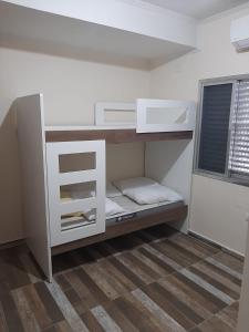 a small room with a bunk bed in it at Apto Praia Grande in Praia Grande