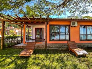 two chairs sitting in front of a house at Pousada Recanto das Flores in Governador Celso Ramos