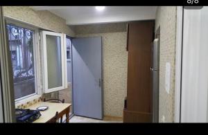 a room with a door and a table and a window at Ann Appartment in Tbilisi City