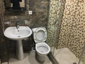 a bathroom with a toilet and a sink at Ann Appartment in Tbilisi City
