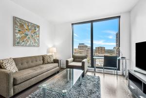 a living room with a couch and a large window at Global Luxury Suites at Reston Town Center in Reston