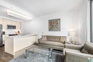 a living room with a couch and a kitchen at Global Luxury Suites at Reston Town Center in Reston