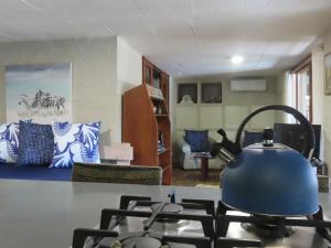 a tea kettle on a stove in a living room at Hennie's Rest in Malelane