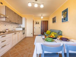 a kitchen with a table and chairs and a kitchen with a tableablish at casa anna in Cala Gonone +23 photos