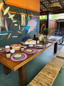 a long wooden table with food on top of it at Tropical Casa Ubatuba in Ubatuba