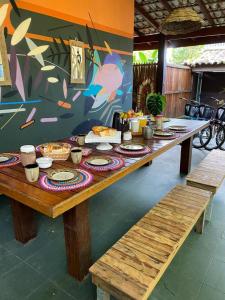 a long wooden table with food on top of it at Tropical Casa Ubatuba in Ubatuba