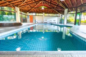 an empty swimming pool in a large building at Pousada Recanto das Flores in Governador Celso Ramos