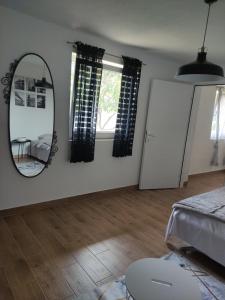 a living room with a mirror and a table at Apartman Ela in Banja Luka