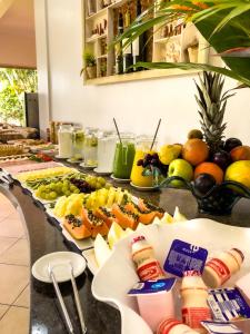 a buffet line with fruits and drinks on it at Pousada Recanto das Flores in Governador Celso Ramos
