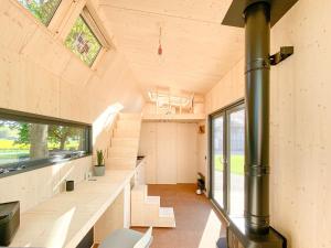 a large room with stairs and a large window at tinyzeit Urlaub im tiny house an der Flensburger Förde in Steinberg