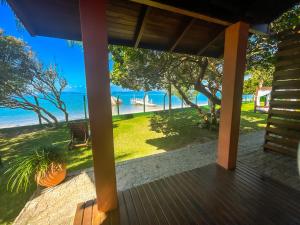 a porch with a view of the ocean at Pousada Recanto das Flores in Governador Celso Ramos
