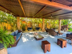 an outdoor patio with furniture and a table at Pousada Recanto das Flores in Governador Celso Ramos +37 photos