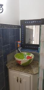 a bowl on a counter in a kitchen with a mirror at Casa De Amor Suites and Tours 