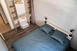 1 dormitorio con 1 cama azul y 2 almohadas en Maison chaleureuse avec exterieur près de la ville, en Lafox