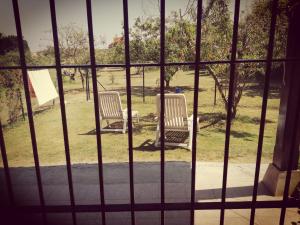 ポオ・デ・リャネスにあるCasa viccocaの窓から見える芝生の上に座る椅子2脚