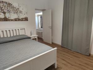 a white bedroom with a bed and a window at Alloggio Turistico C'era una volta in Roccalvecce