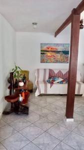 a living room with a couch and a table at Aconchego da Raquel in Itaúnas