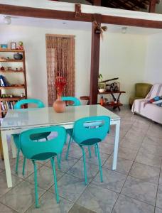 a table and chairs in a living room at Aconchego da Raquel in Itaúnas