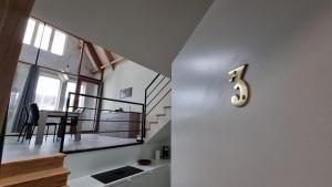 a kitchen and dining room with a number three on the wall at Residence Rossella - App 3 in Roeselare