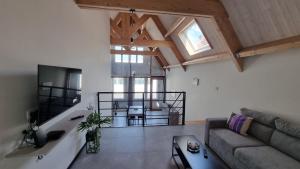 a living room with a couch and a table at Residence Rossella - App 3 in Roeselare