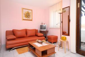 a living room with a couch and a table at Apartments by the sea Kosljun, Pag - 3321 in Košljun