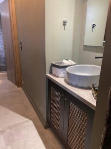 a bathroom with a sink and a mirror at Unique space in Gerakas - Cave in Athens +51 photos