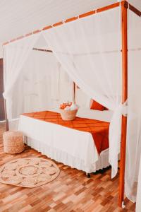 a bedroom with a bed with a canopy at Prana Eco Villa in Atins