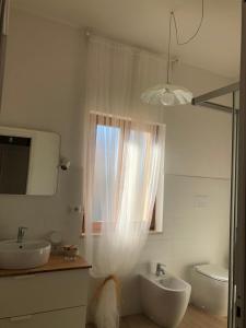 a bathroom with two sinks and a window at Casa giardino santadi in Santadi +17 photos