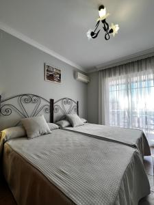 A bed or beds in a room at Hotel Arco del Sol