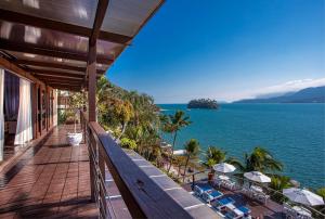 a balcony of a house with a view of the ocean at Barra do Piuva Porto Hotel in Ilhabela