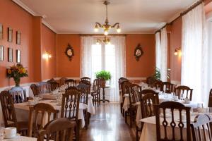 a dining room with tables and chairs and a window at Hotel Norte y Londres in Burgos