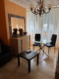 a living room with a table and a laptop on it at Pensión A Pedra in Dumbría