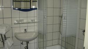 a bathroom with a sink and a mirror at Pension Schottentor in Vienna