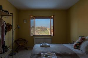 a bedroom with a bed and a window at Villa Ferranti Abruzzo in Montefino