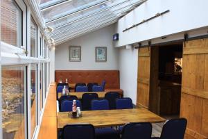 a conference room with a table and chairs at Elmham House - Pilgrim Hotel in Little Walsingham