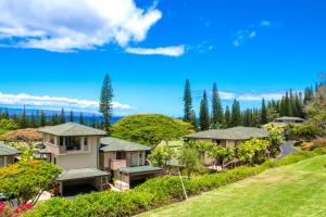 an aerial view of a house with a yard at K B M Resorts- KGV-19P2 Beautifully designed two bed two bath Golf Villa with breath taking acqua marine views in the heart of Kapalua in Kapalua