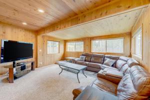 a living room with a couch and a flat screen tv at Escape at Edgewood in Stateline