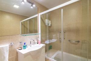 a bathroom with a shower and a sink and a tub at Los Asturianos APART amentos 3 in Mar del Plata