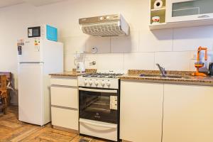 a kitchen with a stove and a refrigerator at APART amento Asturiano 4 Mar del Plata in Mar del Plata +7 photos