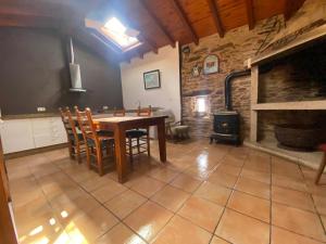 a dining room with a table and a fireplace at Casal de Pedra in Santa Irene
