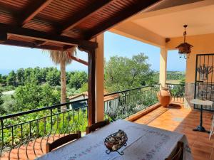 a balcony of a house with a table and a view at House with View in Agia Paraskevi