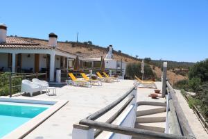 a villa with a swimming pool and a house at Horta da Quinta in Mértola