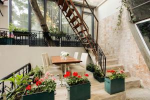 a dining room with a table and some plants at The Loft Istanbul in Istanbul